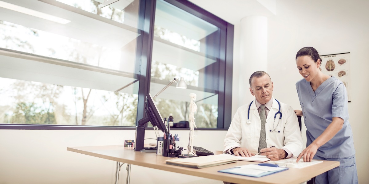 Healthcare professionals reviewing patient charting